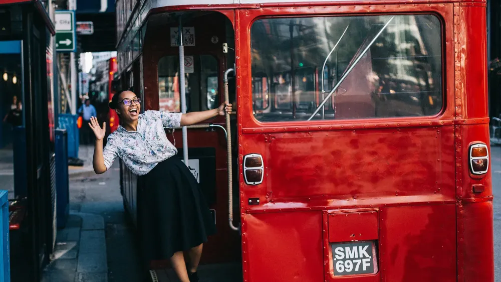 woman hopping on london bus